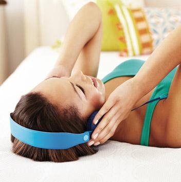 Woman listening to music on Simmons Beautyrest mattress