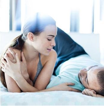 Woman smiling on Simmons Beautyrest mattress